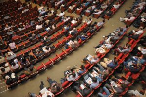 audience in red chairs