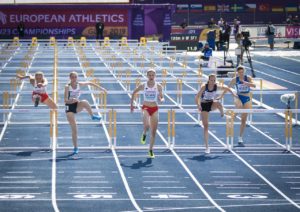women athletes in hurdle race