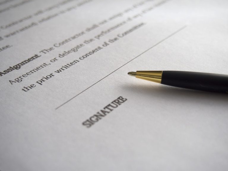 Contract document on table preparing to be signed