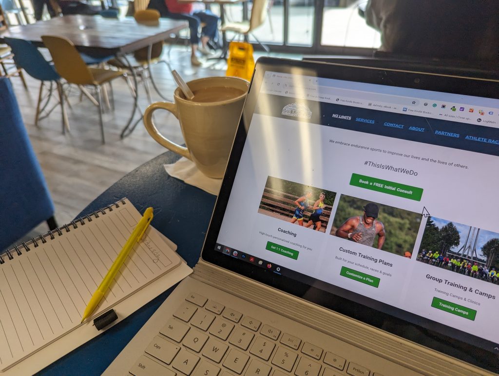 No Limits Coaching website visible on a laptop screen in a coffee shop[