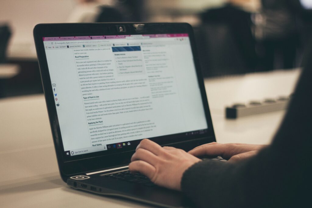 A person typing to add text content to their business website.