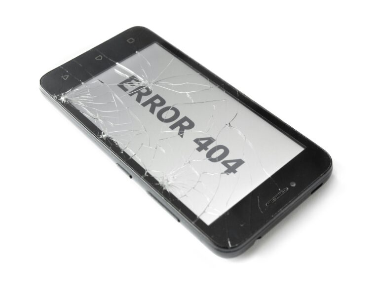 A mobile phone with a cracked screen shows a 404 screen.