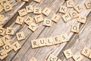 The word "Rules" is spelled out in scrabble letters, representing the regulation and requirements that FINRA requires of financial services websites.