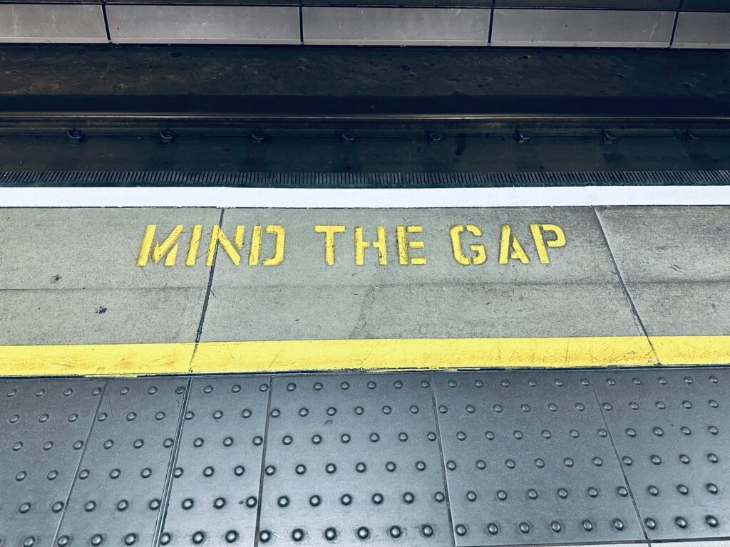An image of the well-known "Mind the Gap" markings on the English subway system.