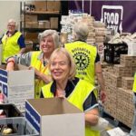 Rotary members work at a food bank.