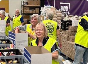Rotary members work at a food bank.