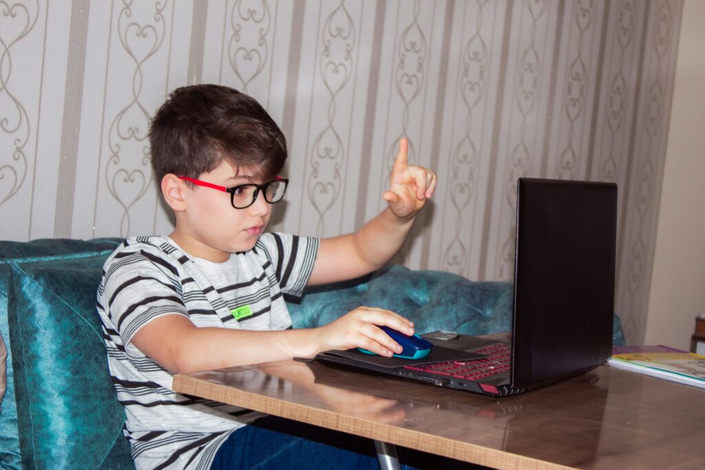 A young boy works on a computer.