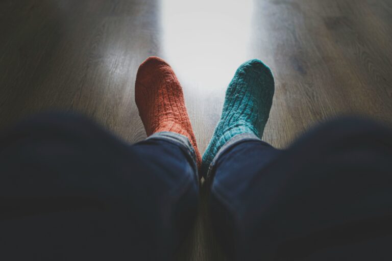 A person wearing a pair of mismatched socks, illustrating the obviousness of mismatched branding assets.
