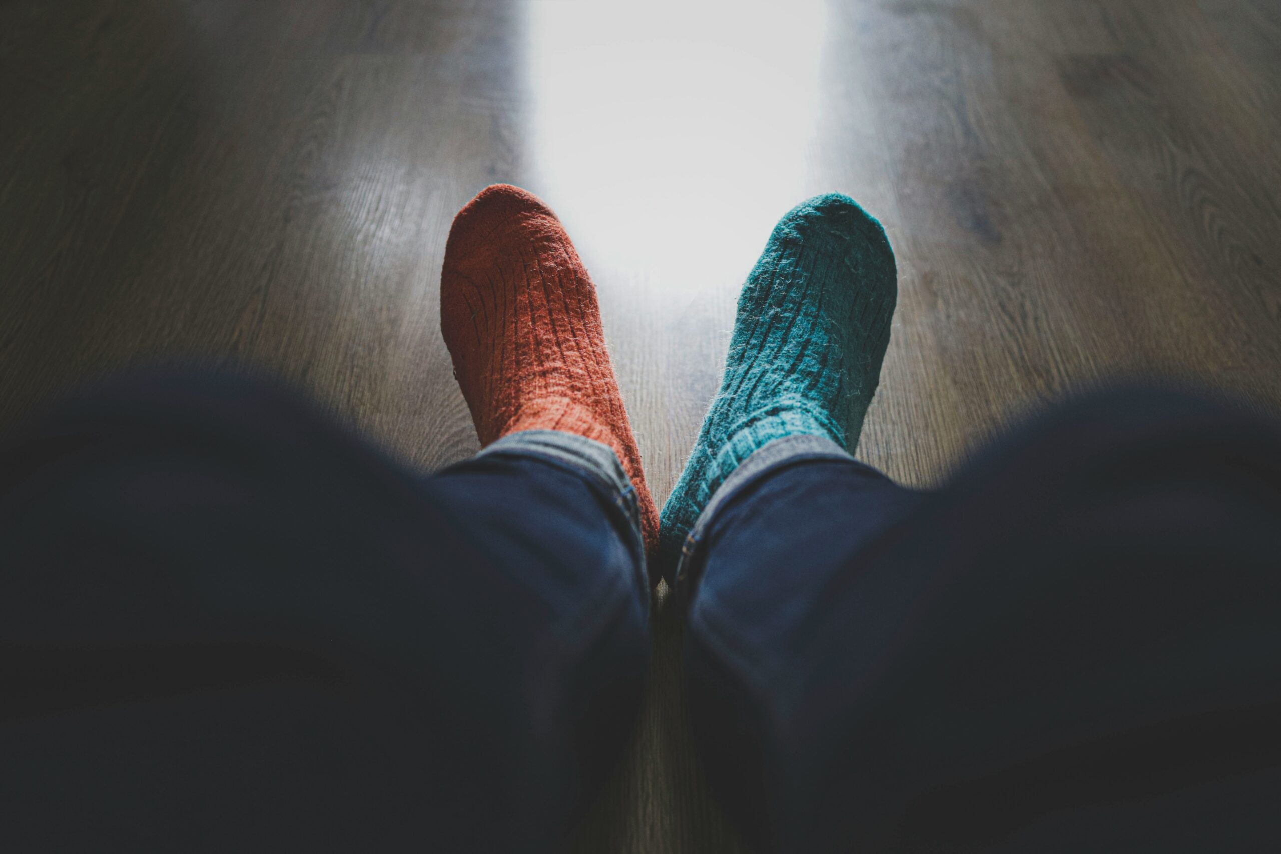 A person wearing a pair of mismatched socks, illustrating the obviousness of mismatched branding assets.