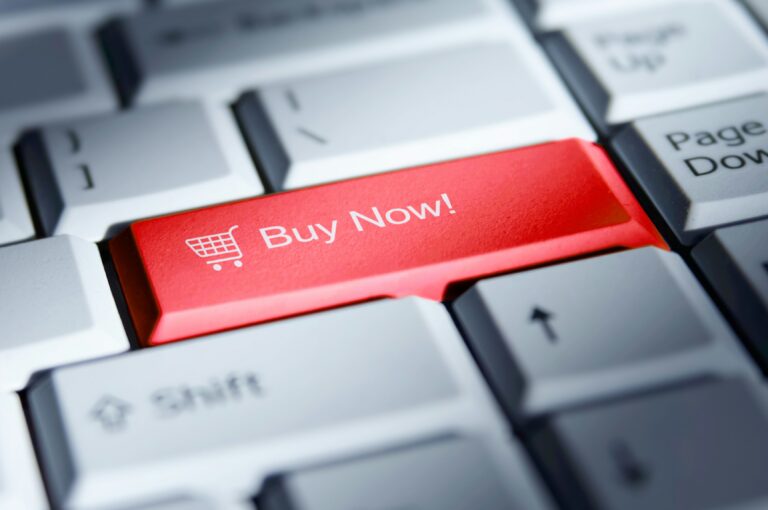 A keyboard features a red "Buy Now" button illustrating e-commerce.
