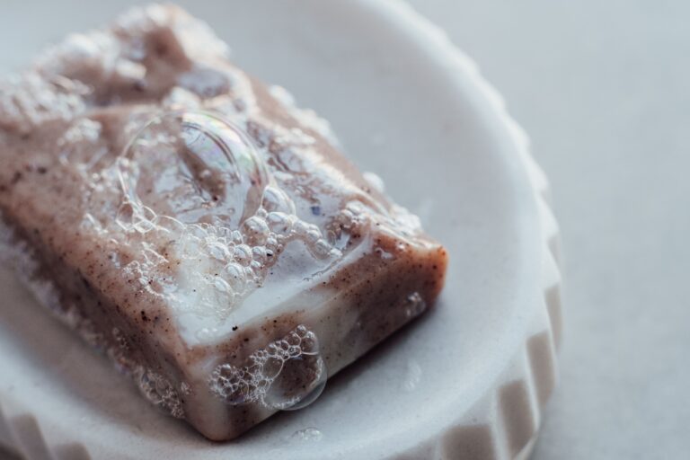 A close-up of a sudsy bar of soap on a soap dish. A nod to the old 'wash your mouth out with soap' punishment, used here to illustrate that EEAT isn't actually the four letter word it might seem.