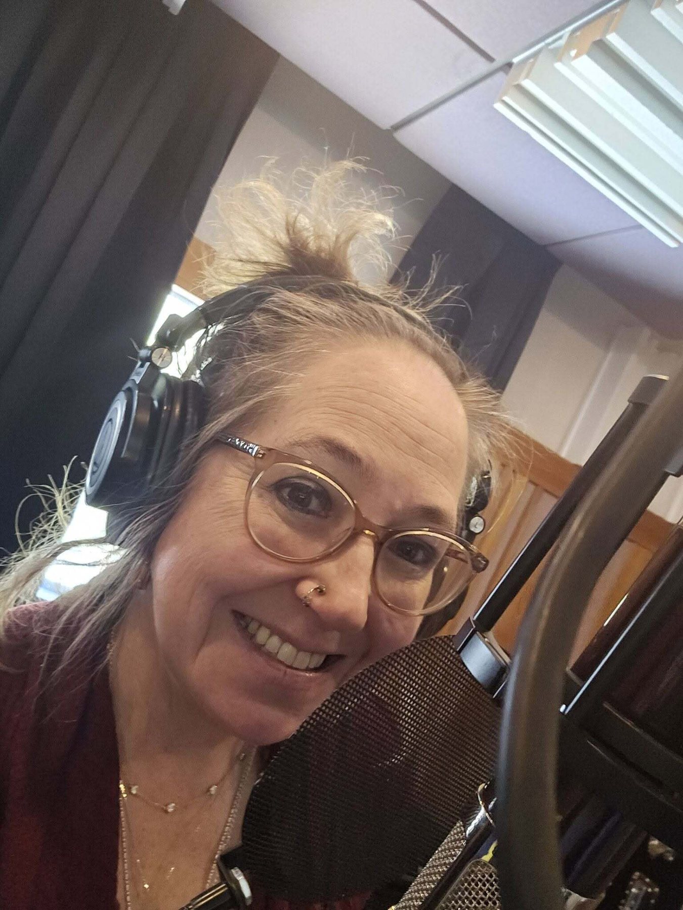 Author Jessica Stokes wearing headphones at the studio microphone